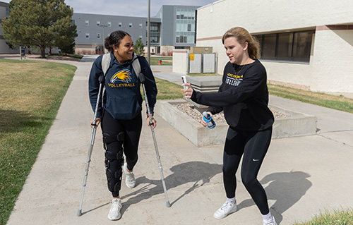 Zoe, left, and Lea, volleyball athletes at LCCC, walk outside of the residence halls. 
