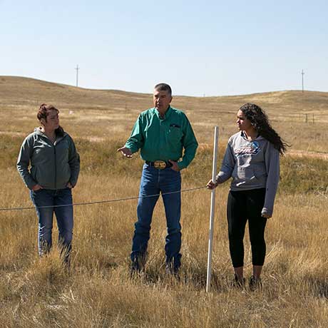 students and a faculty out in the field taking a survey
