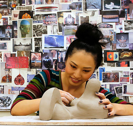 girl working on clay artwork