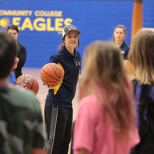 exercise science student teaching kids basketball