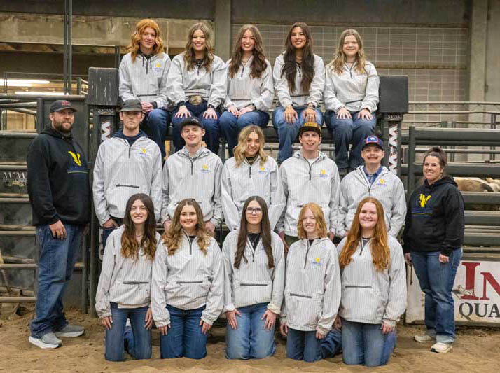 Students who are part of the Livestock Show team lined up with faculty advisors in the arena