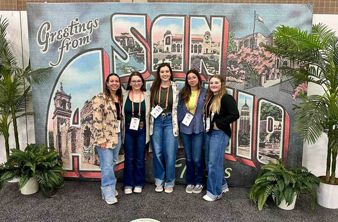 Students and faculty from the Block and Bridle in front of a San Antonio sign on a club trip