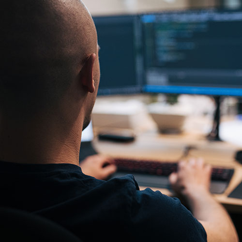 man looking at computer monitor