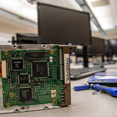 computer motherboard on table near computers