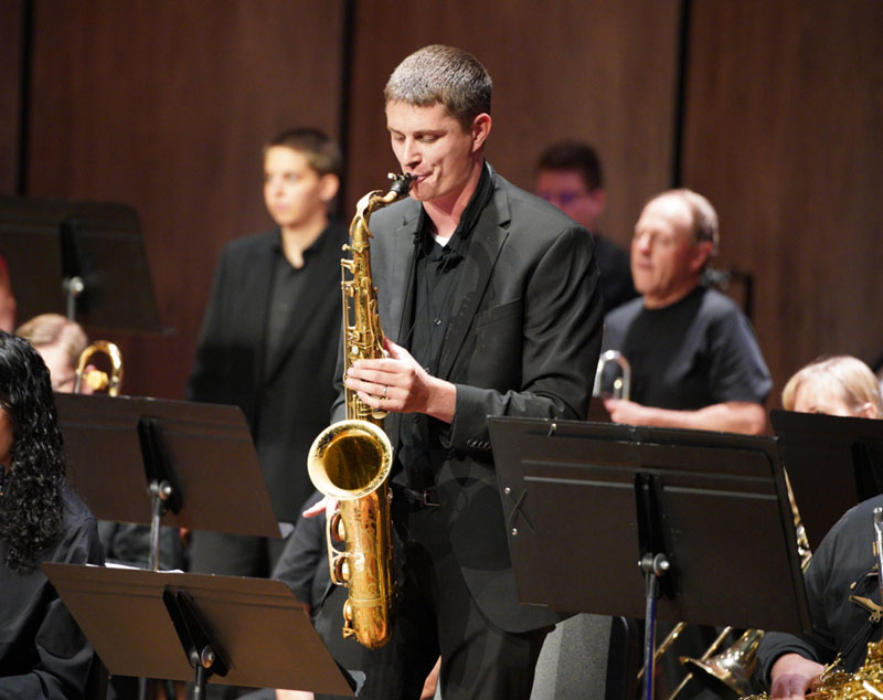 photo of man doing saxaphone solo in a concert