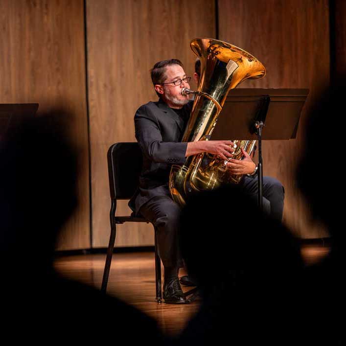 Photo of LCCC Music Faculty on stage playing the tuba