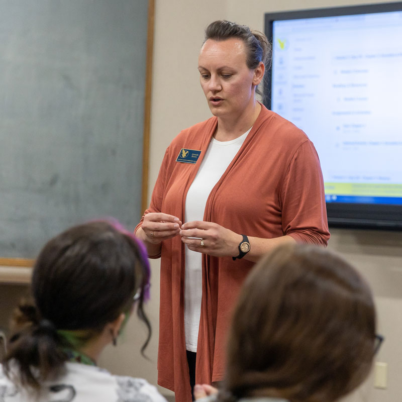 photo of psychology faculty member Amanda Brown speaking to class.