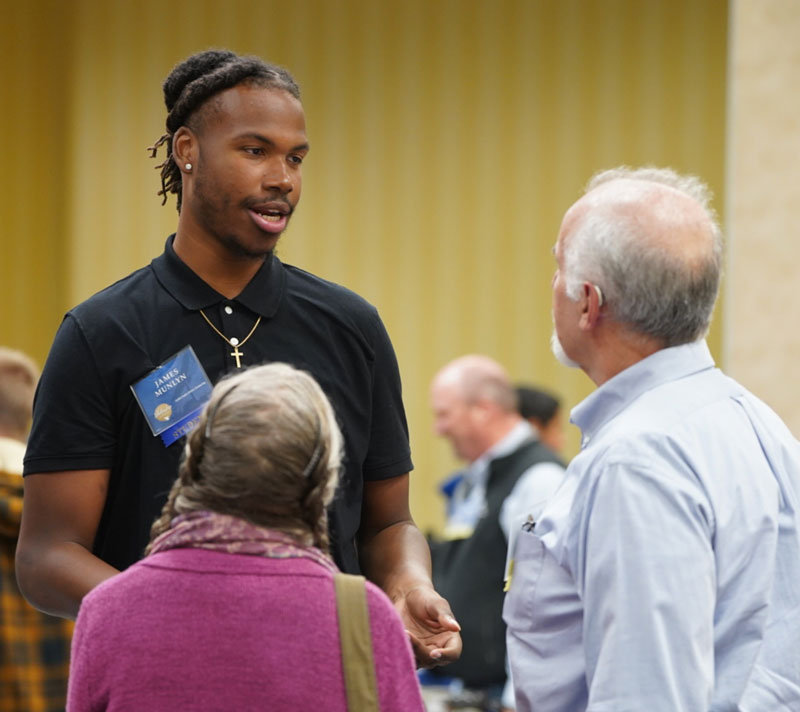 Photo of a student talking with two adults