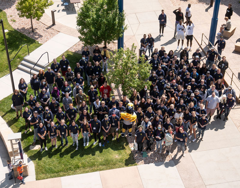 Group of LCCC students standing outside at the Kickoff event and looking up at the photographer on the roof