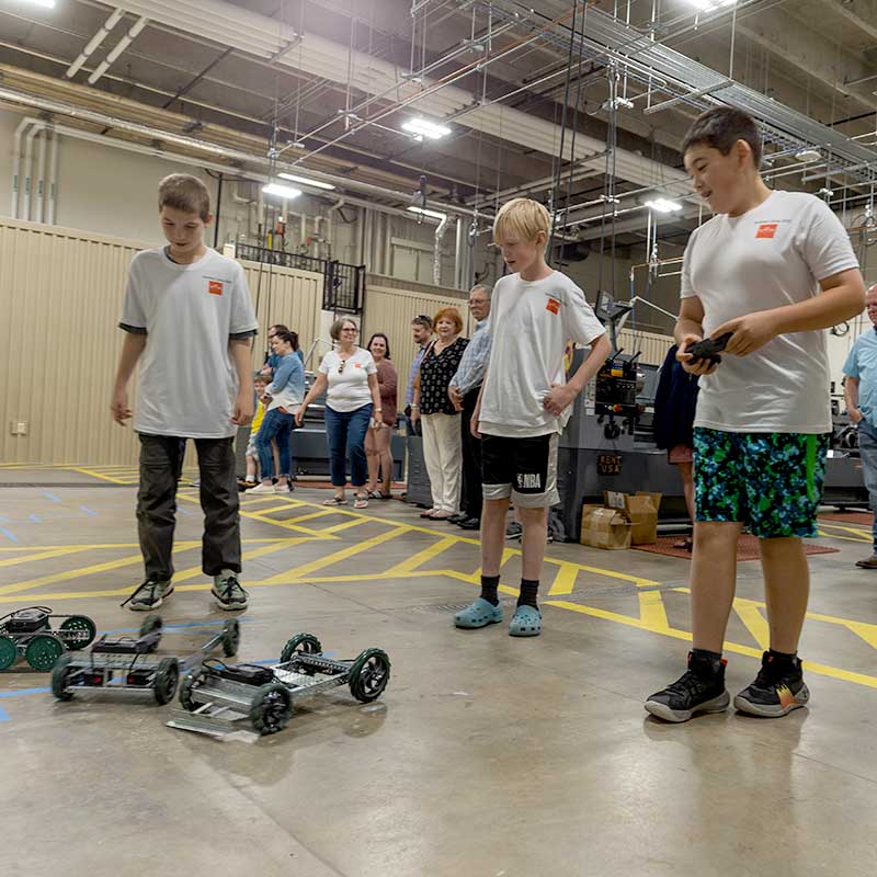 three kids at robotics camp