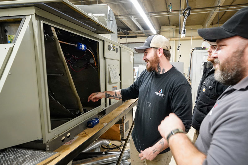 photo of two men working on HVAC