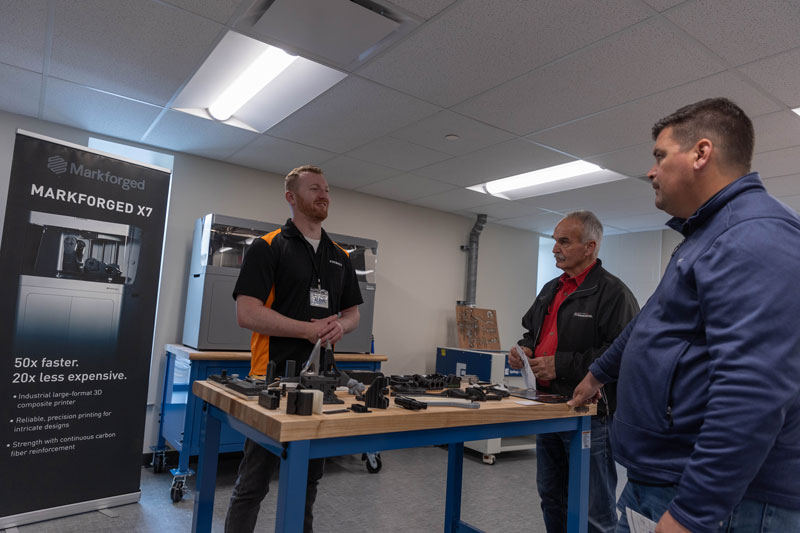 photo of a demo of the Markforged X7 3D printer and sample printed parts