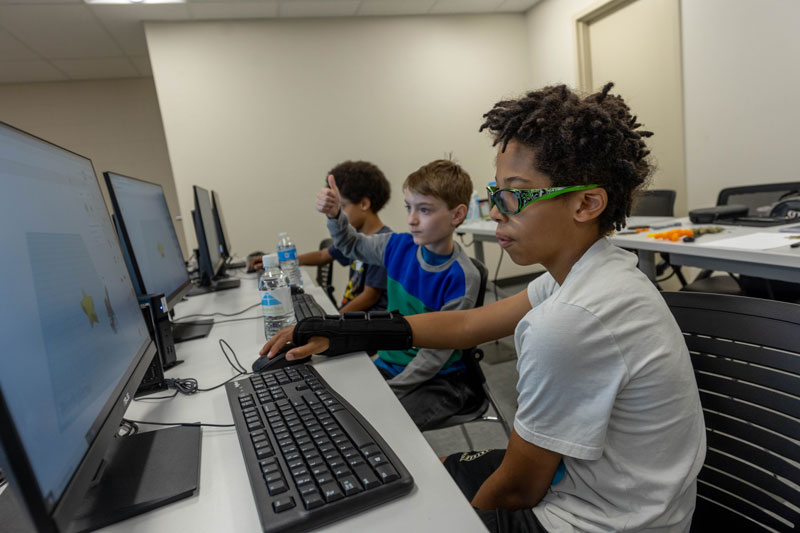 photo of kids working on 3D software in the computer lab