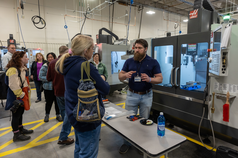 photo of people talking about machines during the AMMC grand opening event