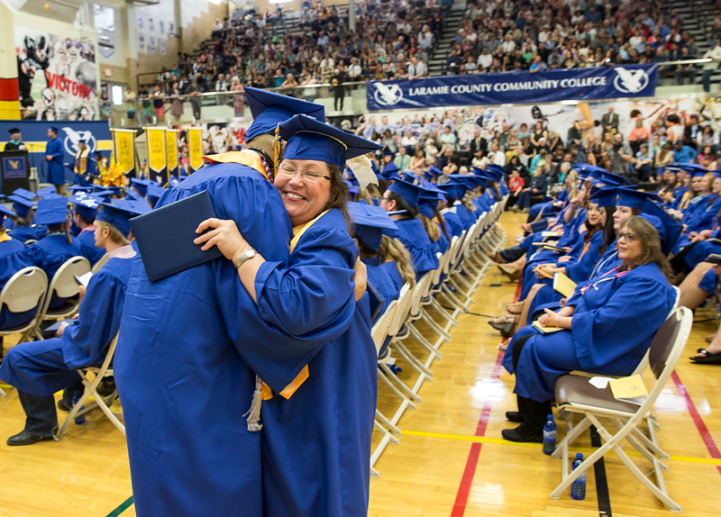 LCCC graduation with two graduates hugging